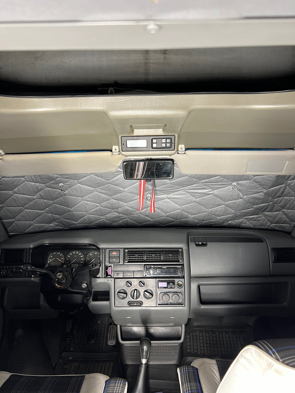 Car interior with dashboard and quilted sunshade