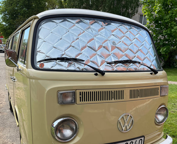 Beige Volkswagen van with a clear windshield on a street